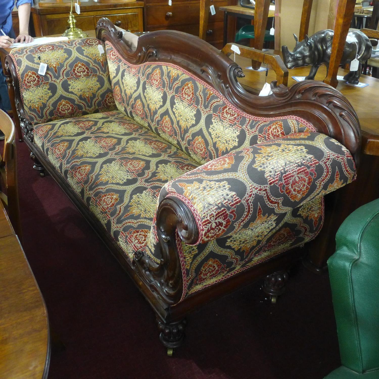 A Victorian carved mahogany sofa raised on turned legs and castors - Image 2 of 2