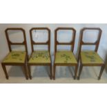 A set of four Art Deco burr walnut dining chairs, with inlaid square framed back rests, raised on