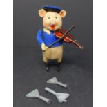 A vintage Schuco wind up toy, pig playing violin