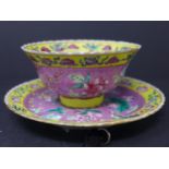 A Chinese porcelain dish, decorated with a stork to centre within stylised flowers on a pink ground,