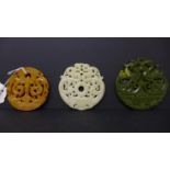 Three, hand-carved, hard-stone circular, Chinese amulets/pendants in shades of dark green, white and