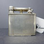 A silver Dunhill novelty compact modelled in the form of a lighter, having engine turned decoration,