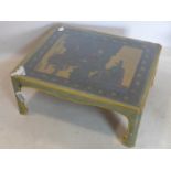 An early 20th century Chinese coffee table, crackle painted with part gilt, inset with painted and
