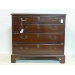 An early 19th century mahogany chest of four graduating drawers, oak lined, raised on bracket