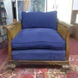 An Edwardian Chippendale style mahogany bergere armchair, with double caning, raised on paw feet