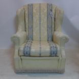 A 20th century wing back armchair with damask upholstery