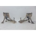 A pair of silver plated cornucopia stands, modelled as goats, missing glass slips, H.13 L.18cm,
