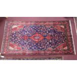 A North-West Persian Nahawand rug, central diamond medallion with repeating petal motifs on a