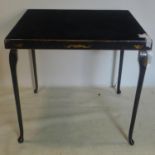 A late 19th/early 20th century gilt painted ebonized folding table, with felt top, H.69 W.77 D.77cm