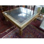 An iron bound teak coffee table, with iron mesh grate and glass top, H.42 W.100 D.100cm