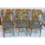 A set of 7 oak country house style dining chairs, to include 2 carvers