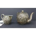 A 19th century Gem Woo Chinese canton silver tea pot, H.12cm, and matching jug, with broken
