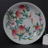 A Chinese porcelain dish adorned with a pair of bats, plump peaches and foliage on a white ground H: