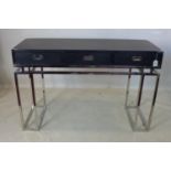 WITHDRAWN A campaign style 2 drawer console table, raised on chrome base, H.79 W.120 D.45cm