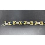 A boxed, 10ct yellow and white gold bracelet alternately set with 10 marquise-cut sapphires and