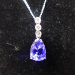 A boxed 18ct white gold diamond and tanzanite pendant on a 9ct white gold chain, pendant L: 1.7cm,