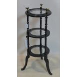 A Regency style ebonised three tier cake stand, with three bird finials to top, each circular tier