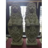 A pair of reconstituted stone armorial lions, raised on square stepped bases, H.80cm