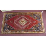 A South-West Persian Qashqai carpet, central diamond medallion with repeating petal motifs and