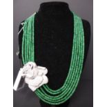 A 6 strand, natural faceted emerald bead necklace with white metal clasp and crystal-studded