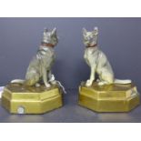 A pair of Alsatian bookends, raised on stepped brass bases, H.16 W.12 D.8cm