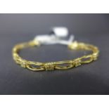 A 15ct yellow gold and diamond bracelet, the 10 links inter-spaced by 11 diamond clusters of 4