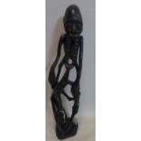 An African Makonde abstract carving of dancing figures, H.69cm