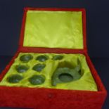 A boxed Chinese jade tea set, to include teapot, six cups and a tray, H.7 W.12 D.17cm (teapot), W.22