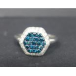 An 18ct white gold, diamond and 'fancy intense' blue diamond ring of hexagonal form