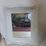 A white painted wall mirror, with rectangular glass plate and floral decoration to frame, 55 x 64cm