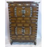 A late 19th/early 20th century Korean marriage cabinet, in 2 sections with white metal mounts and