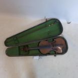 An antique violin in vintage wooden travel case