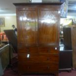 A Regency mahogany linen press, the reeded cornice above 2 paneled doors, enclosing 4 linen trays,