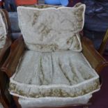 A pair of walnut berege armchairs with floral cushions