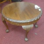 A 20th century mahogany occasional table, with circular top, raised on cabriole legs and claw and
