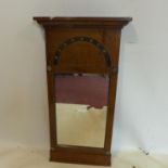 An Empire period inlaid and brass mounted mahogany pier mirror, with moulded cornice above