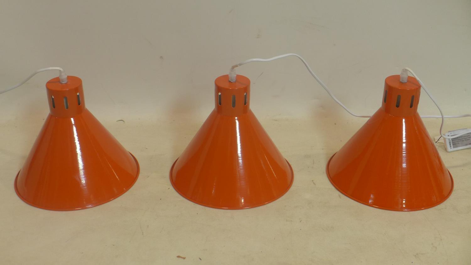 A set of 3 brand-new orange enamelled metal ceiling lights (white enamel interiors) complete with