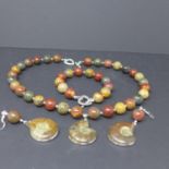 A white metal, 'Picasso' jasper and Jurassic ammonite suite to include polished bead necklace,
