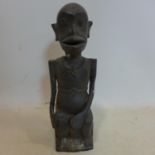 An early 20th century Indonesian cast bronze study of a seated figure, H.34cm