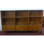 A 20th century teak unit with adjustable shelf space, above 6 drawers, raised on tapered legs, H.