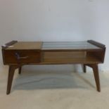 A 20th century G-plan teak coffee table, with glass top and single drawer, raised in splayed legs,