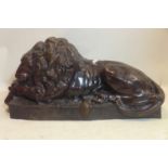 A 20th century large cast bronze study of a recumbent lion, H.51 W.114 D.45cm