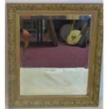 A Victorian rectangular giltwood mirror, with bevelled glass plate and floral decoration to frame,