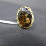 A 9ct yellow gold and smokey quartz ring, with pierced mount, hallmarked, bearing makers mark G&T.J