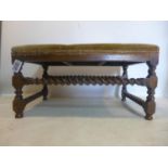 A large 19th century oak stool, with tapestry upholstery, raised on barley twist supports and