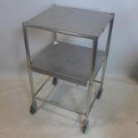 A vintage chrome medicine trolley, raised on castors, H.83 W.51 D.45cm