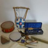 A collection of vintage musical instruments to include a Delaney drum and a French claranet in case