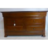 A contemporary cherry wood dressing chest, with hinged mirror top enclosing fitted interior, above 4