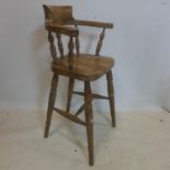 A late 19th / early 20th century pine child's high chair, on turned supports joined by stretcher,