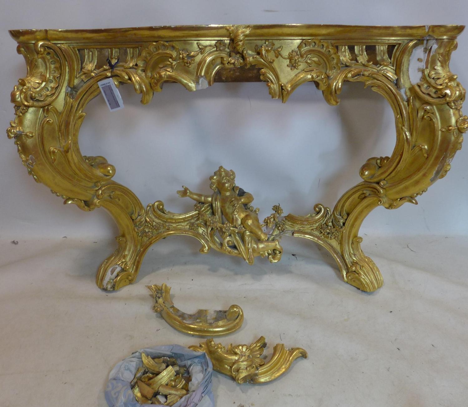 A 19th century Rococo gilt wood and gesso console table, some pieces need re attaching, lacking